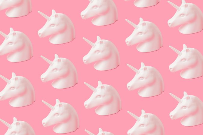 Bust of unicorn in rows on pink background
