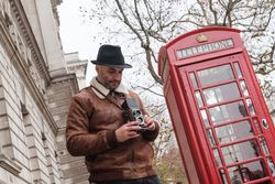 Male photographer near red telephone box