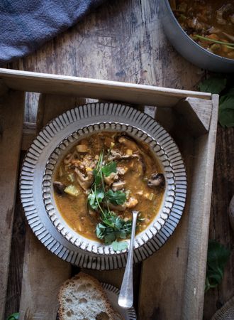 Bread and parsley near quinoa soup