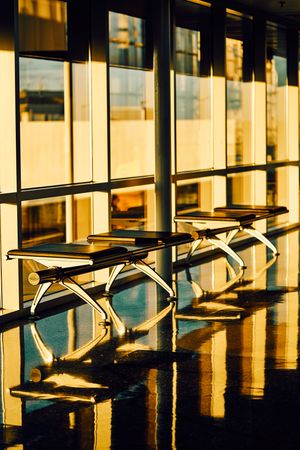Long bench with soft seat nearby glass wall