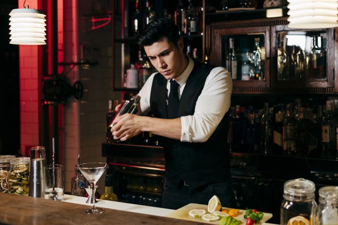 Barman working mixing drinks in a shaker
