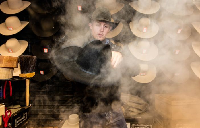 Denver man steaming a cowboy hat for display