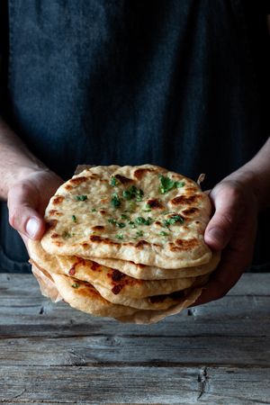 Crop man demonstrating naan bread
