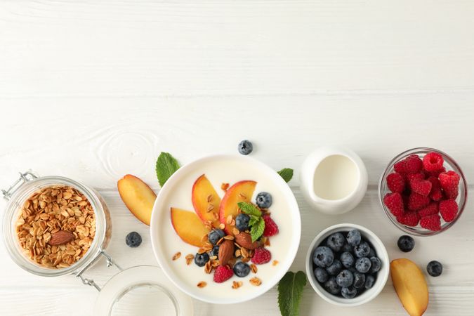 Flat lay composition with parfaits dessert and ingredients on wooden background