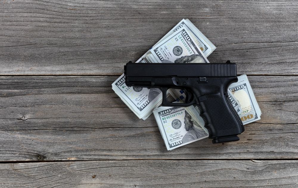 Weapon business with pistol and cash