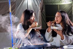 Two Young People Eating Beef