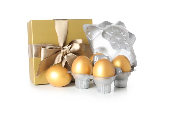 Concept of Richness, golden eggs, isolated on blank background