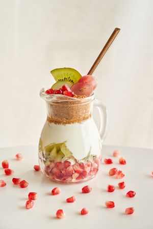 Delicious yogurt dessert with pomegranate, kiwi, grape and ginger biscuit
