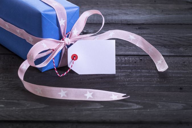 Gift box in blue paper with label tag
