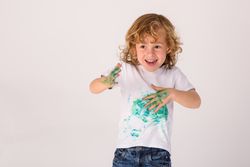 Cheerful boy with dirty t shirt