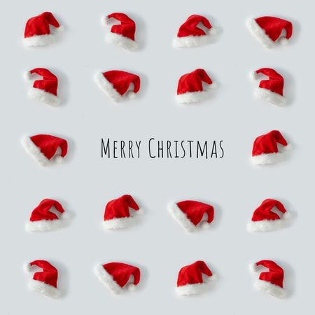 Santa hats arranged on light background, with “Merry Christmas”