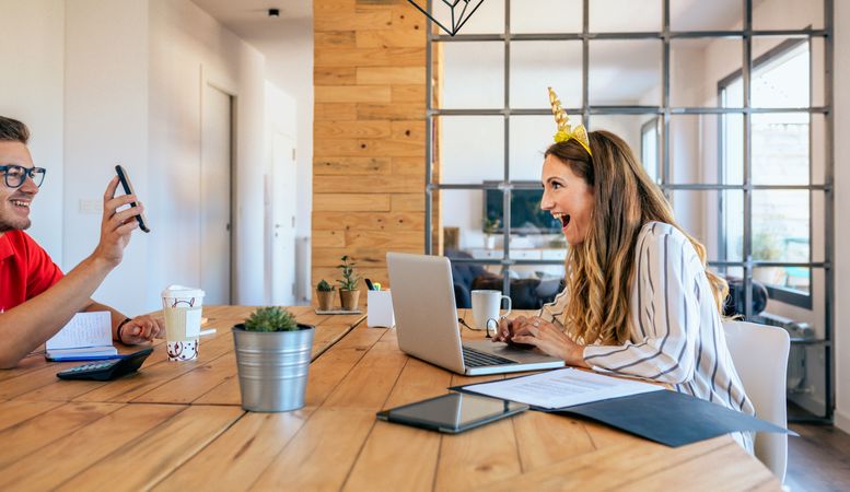 Funny business woman with unicorn headband surprised