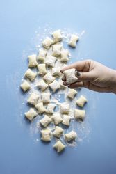 Woman hand holding freshly cut gnocchi