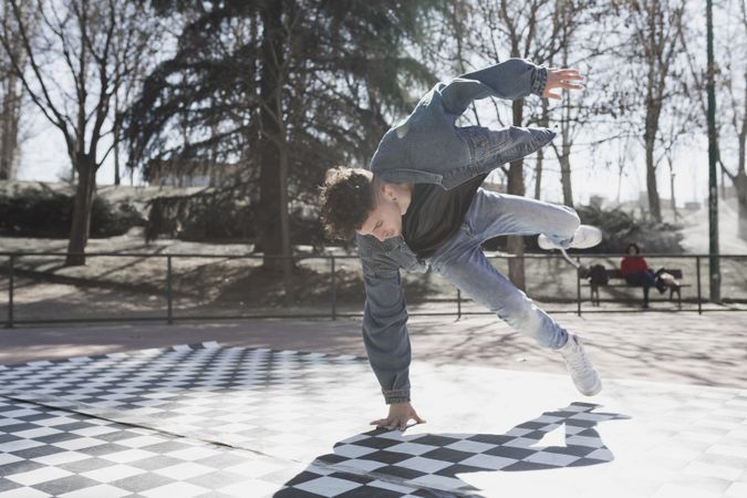 Man dancing break dance in park