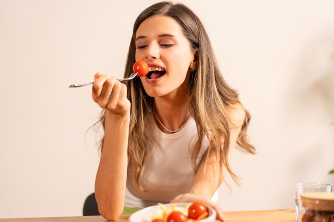 Woman Eating Cherry Tomatoes - Healthy Snack and Lifestyle