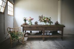 Bunches of flowers in vases on table