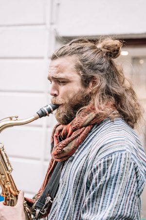 Male saxophonist plays Sax in the street