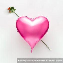 Pink heart balloon with rose on light background bGAXA5