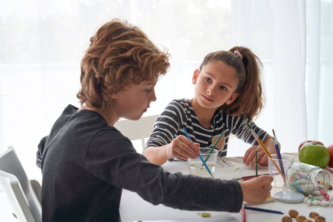 Cute children painting at table