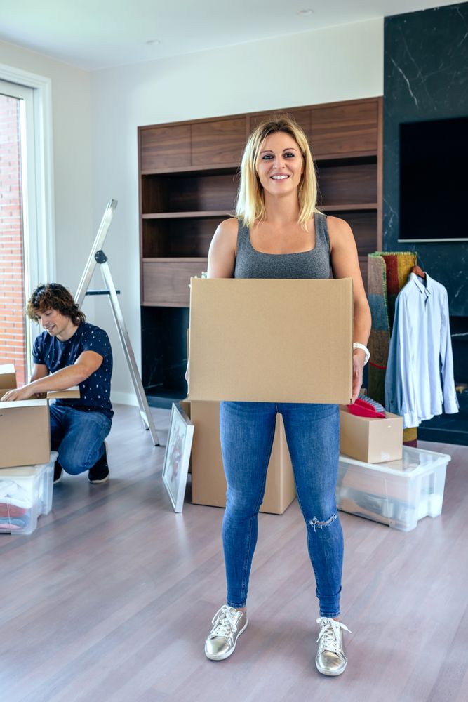 Woman carrying moving box