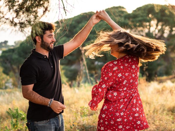 Young happy couple embracing in beautiful garden
