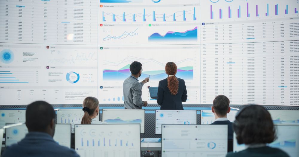 Multiethnic Employees Working On Desktop Computers for AI Company.