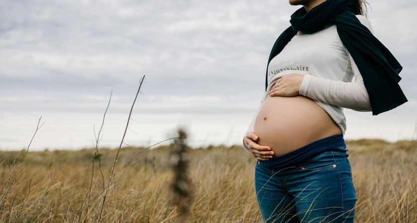 Pregnant woman holding her tummy