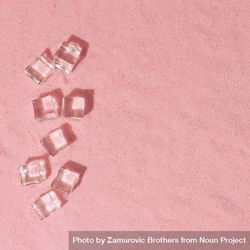 Flat lay of ice cubes on pink sand background with shadows 5nQr80