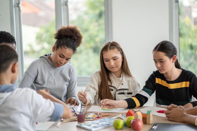 Young teens in painting class at school