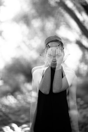 Double exposure shot of woman with hands over her eyes and eyes showing