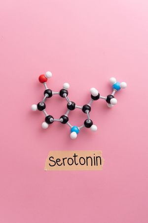 Serotonin molecular structure over pink background