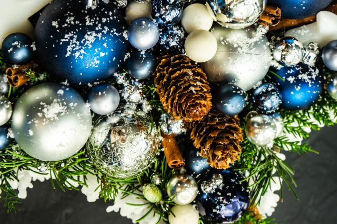 Top view of blue and silver Christmas decorations in pine branch