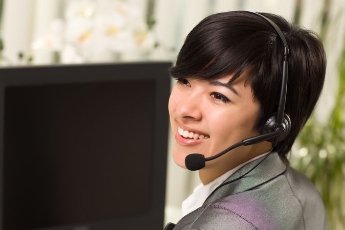 Young Woman Smiles Wearing Headset