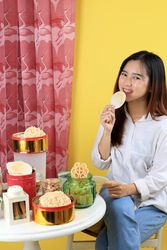 Young Woman Eating Traditional Snack Popular for Eid Al Fitr