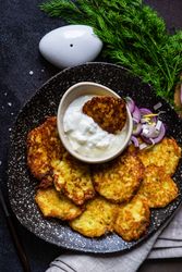 Top view of traditional Ukrainian dish deruny with dipping sauce