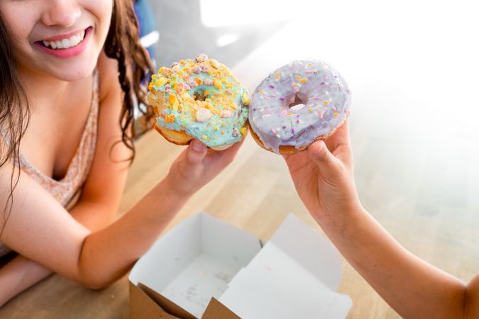 Women enjoying decorated donuts