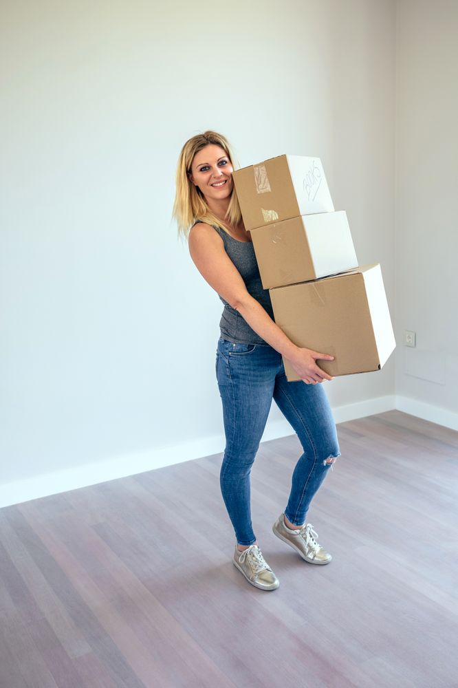 Woman carrying moving boxes