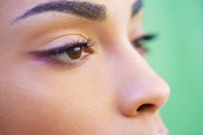 Close up portrait of Black female in front of green background