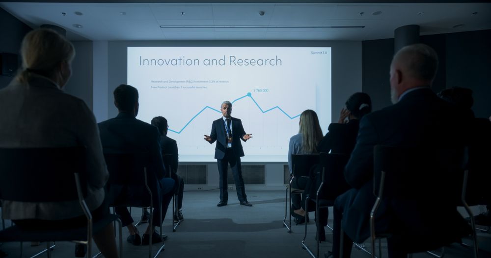 Corporate Event: Male Tech CEO Giving Presentation To Colleagues or Investors In the Conference Room Of Innovative Startup Office.