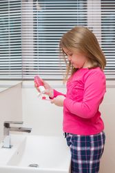 Cute girl brushing her teeth