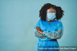 Black female medical professional in surgical PPE with her arms crossed 42P7y0