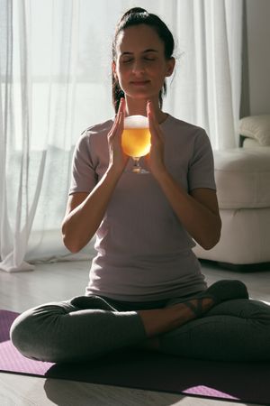 Woman meditating with beer