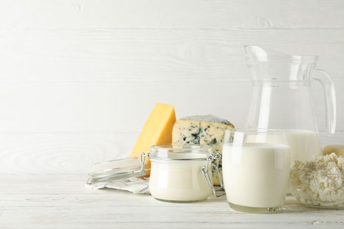 Different dairy products on wooden background, copy space