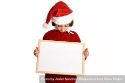 Child in Santa outfit holding blank board 5nJDn5