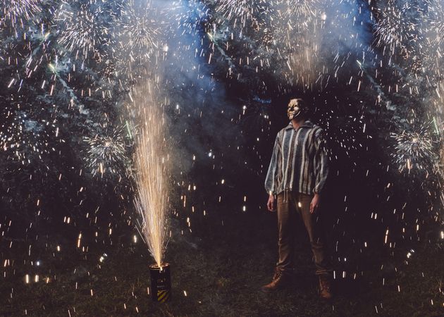 Masked man surrounded by fireworks