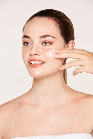 Amiable female taking care of face