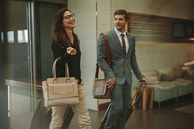 Business travelers walking through airport lobby