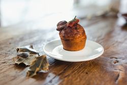 Plate with muffin on wooden table