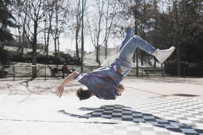 Man dancing break dance in park