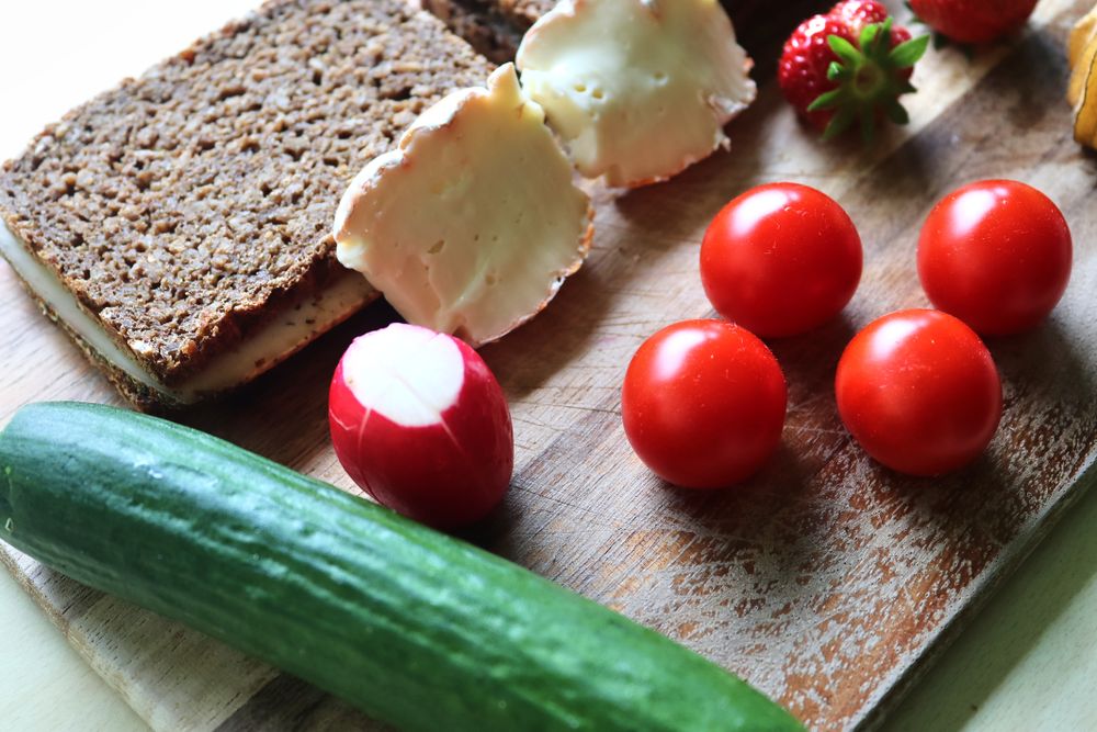 Close view on a healthy german breakfast with sandwiches, tomatoes and cucumbers